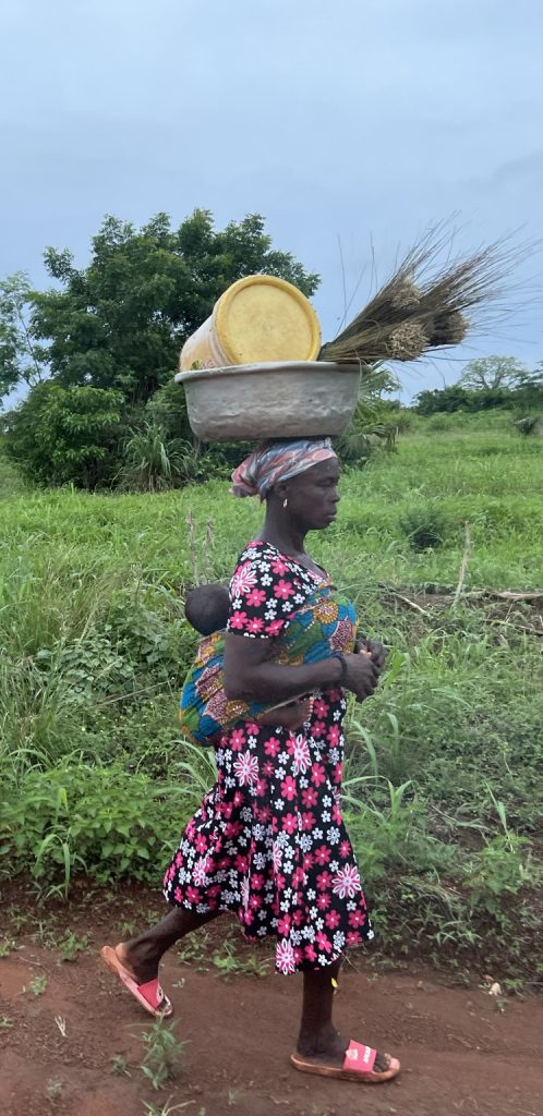 african woman carrying basket on head